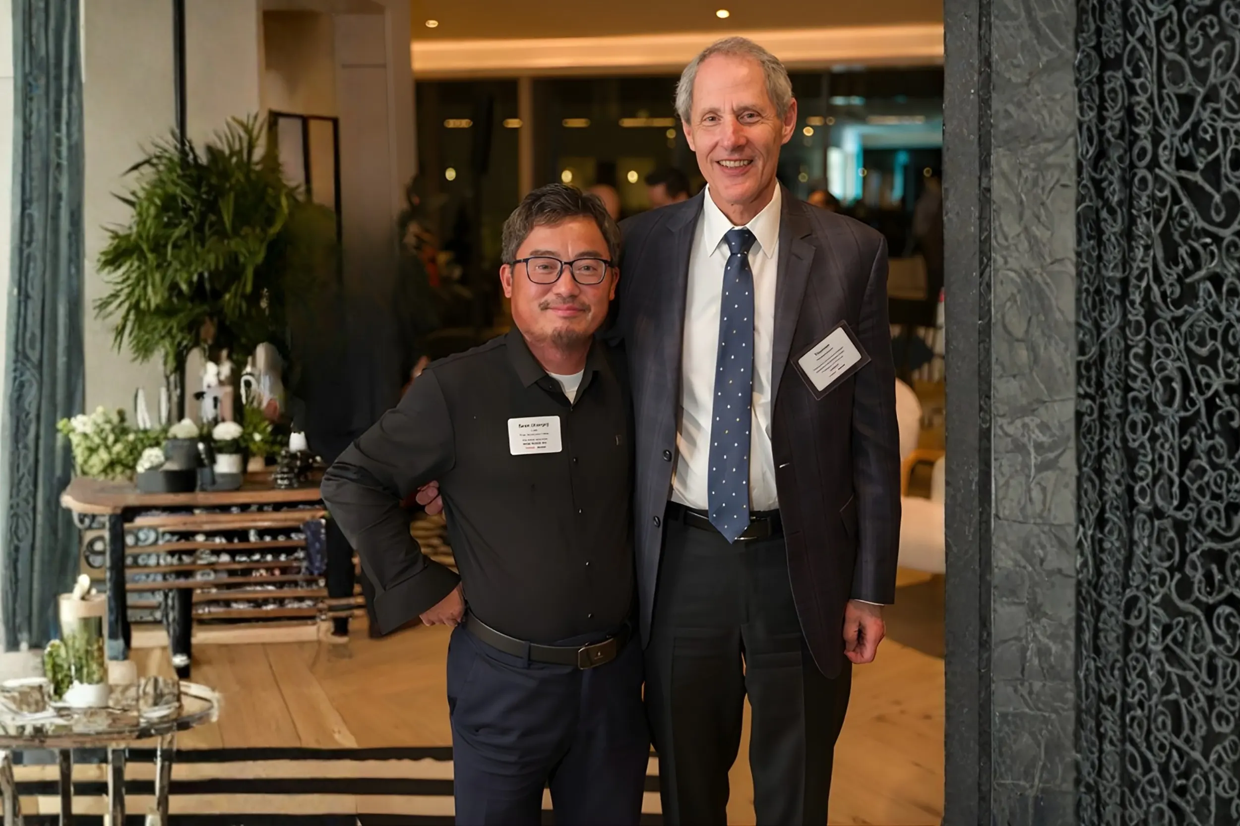 Dr. Sean Lee with another attendee at Caltech alumni event, name badges visible
